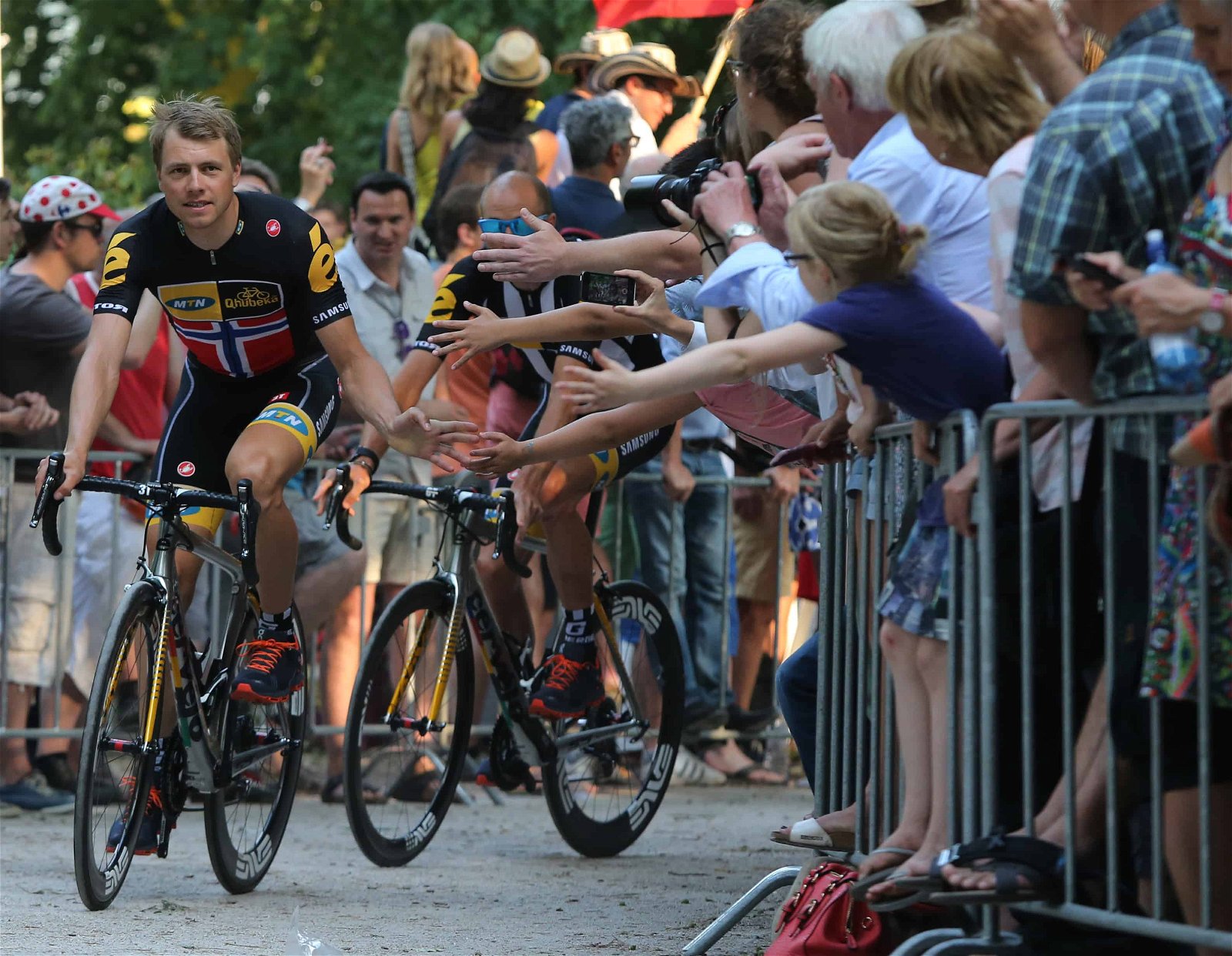 Supporters moedigen voorbijrijdende wielrenners aan tijdens de Tour de France.