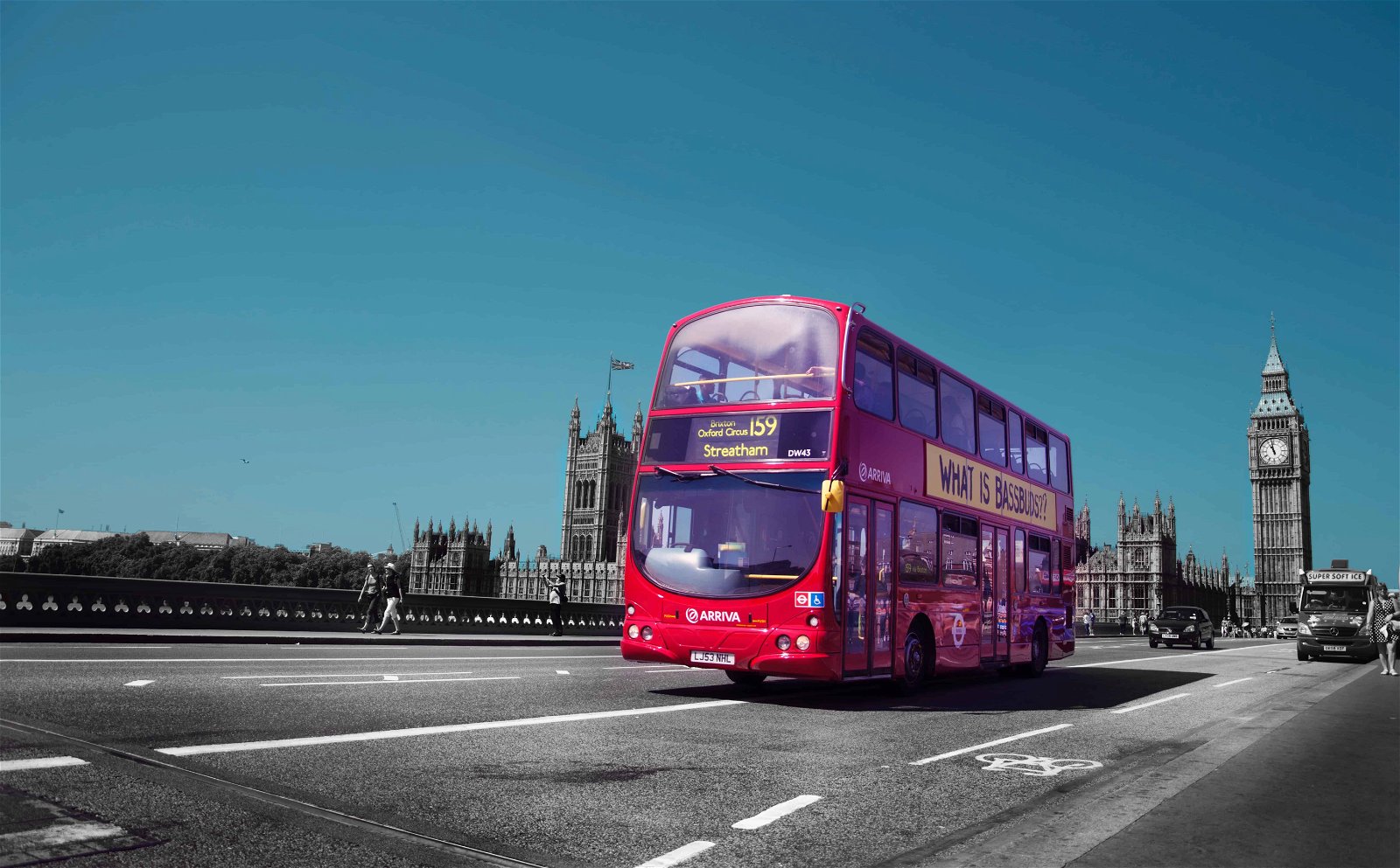 Een rode bus rijdt over een brug in Londen.