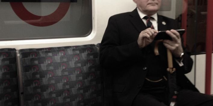 London business man hat tube subway texting