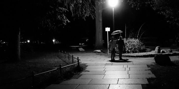 dark night couple umbrella street
