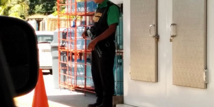 Armed guard, petrol station, Roatan, Honduras, Central America