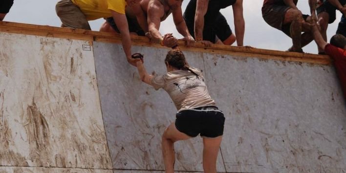 help woman wall climb obstacle